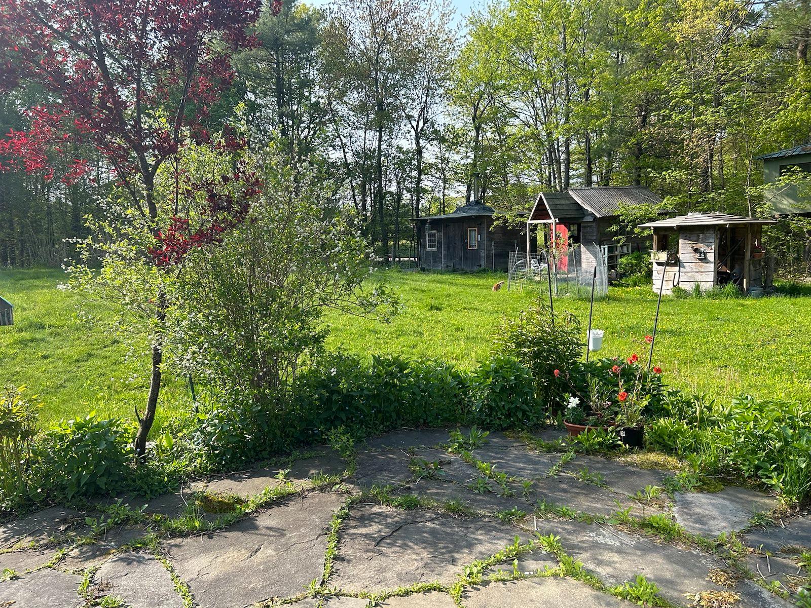 Patio view to the south; across the front yard there are views of the valley. Center background (with windows and chimney) is Rocky Hill Forge, our son’s blacksmith forge.